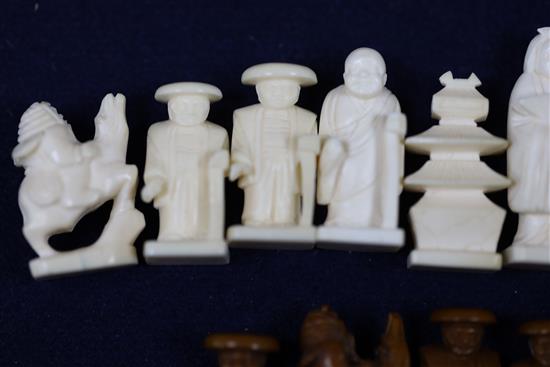 An unusual late 19th century Japanese brown stained and natural ivory figural chess set, kings 1.75in.